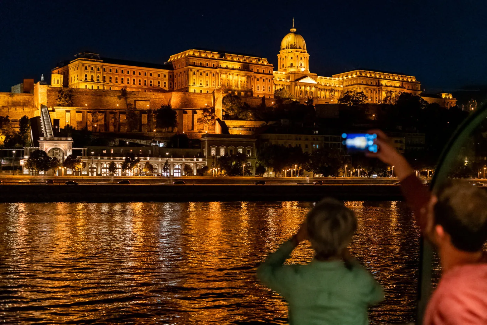 A guest photographing Buda Castle from the deck