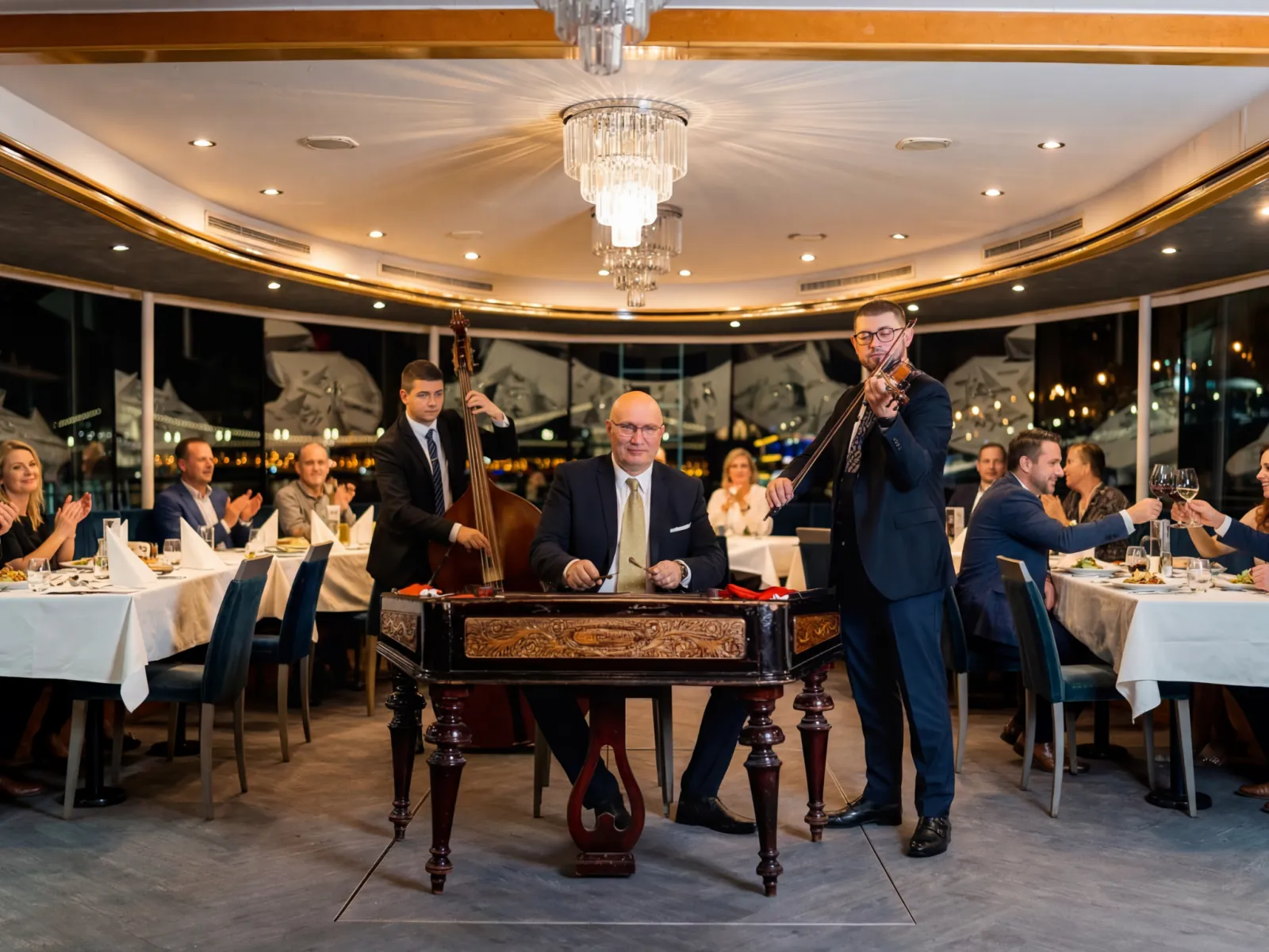 Musicians on cimbalom, violin and bass in the restaurant salon