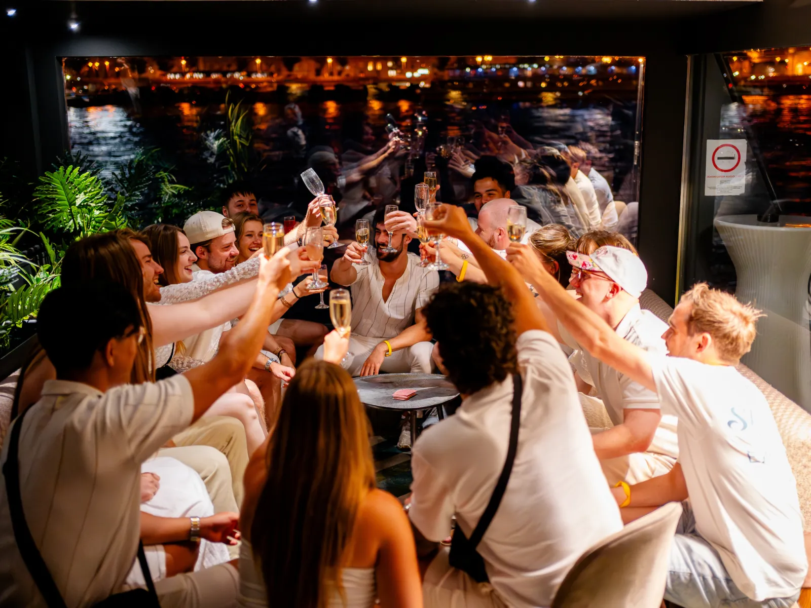 A full deck of guests toasting at night