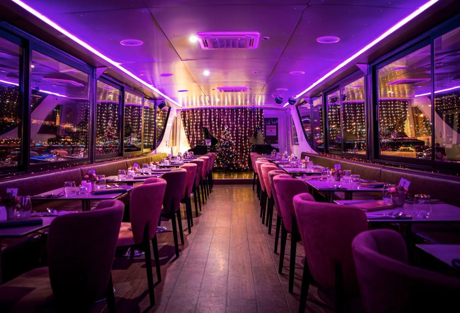 The purple-lit dining salon set for dinner