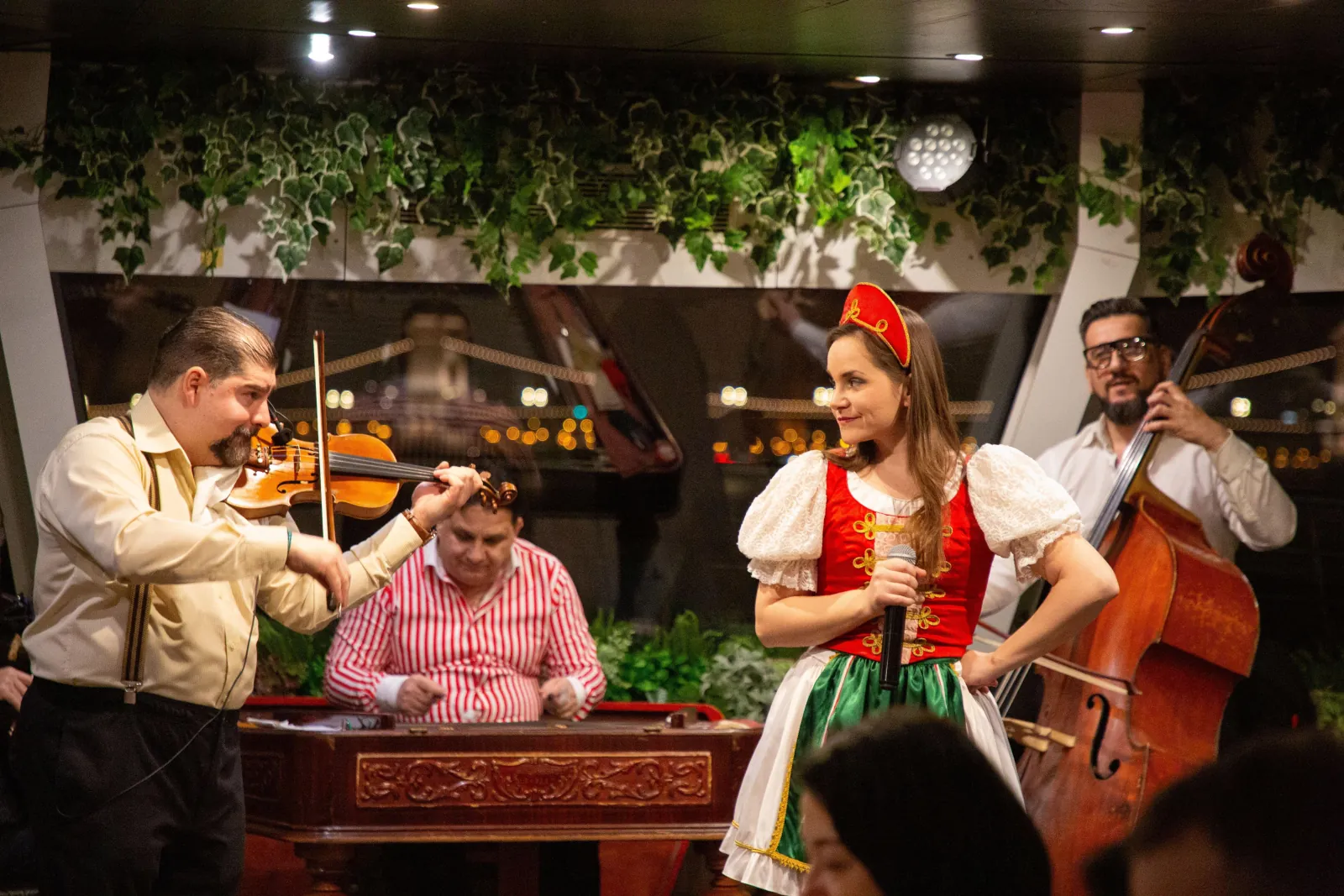 A folk band and singer performing in the dining room