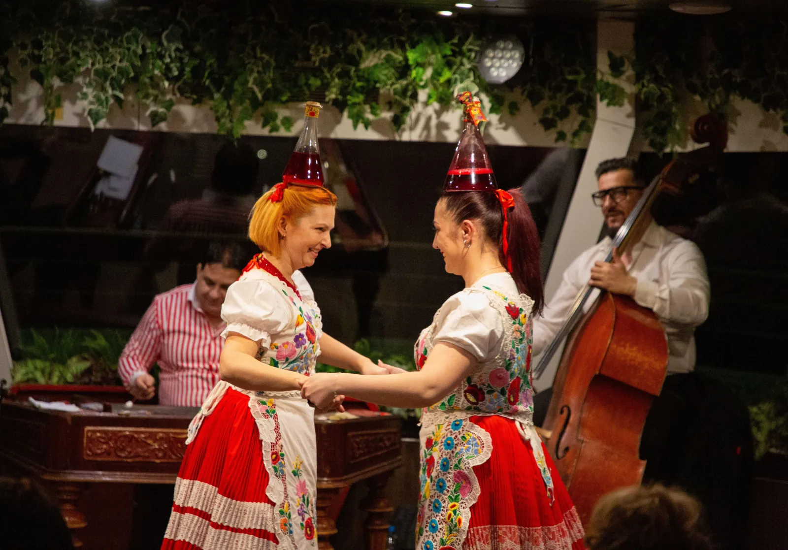 Two dancers in Hungarian folk dress mid-dance