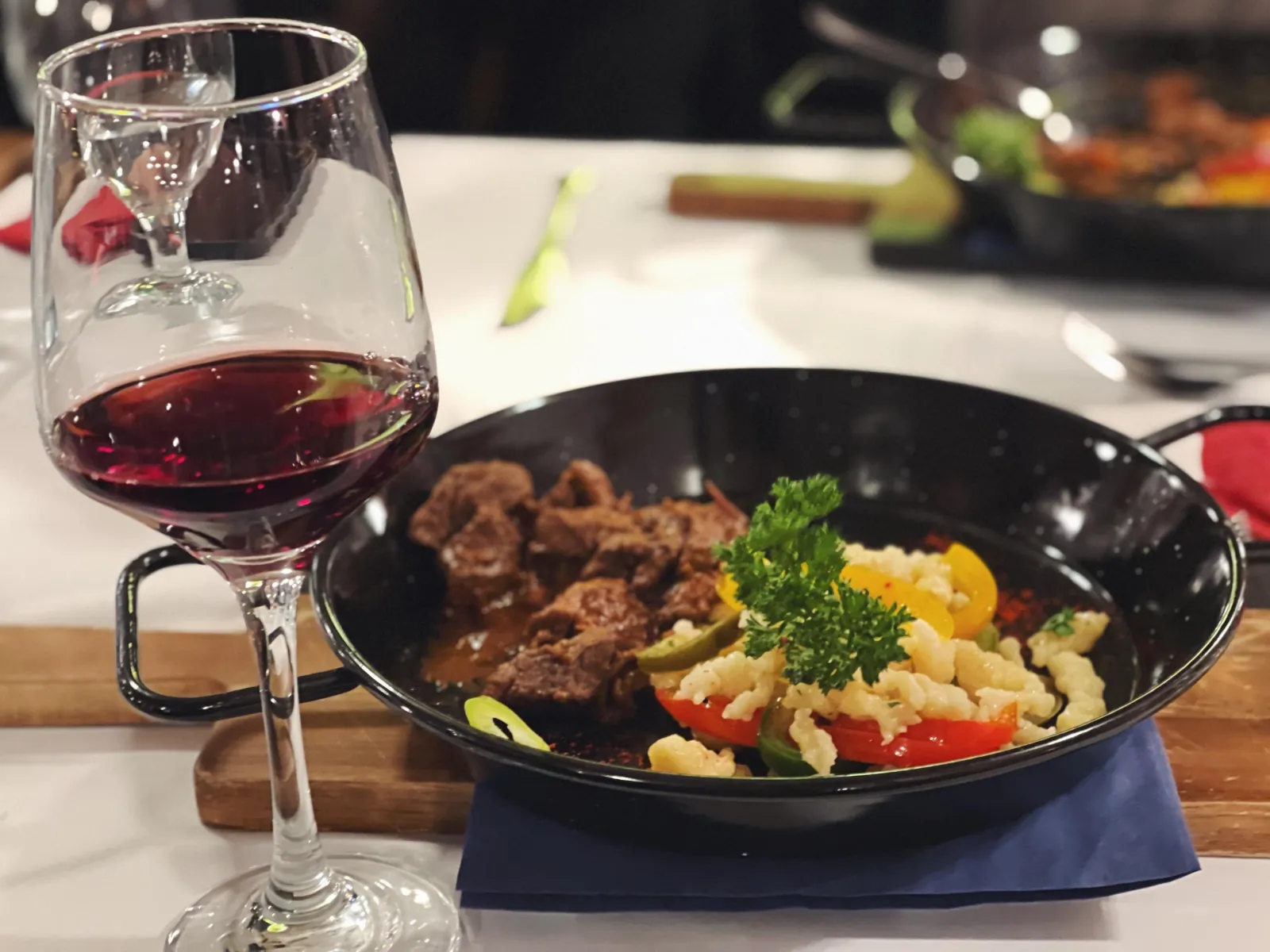 Beef stew with pasta and a glass of red wine on the wine-and-dine cruise