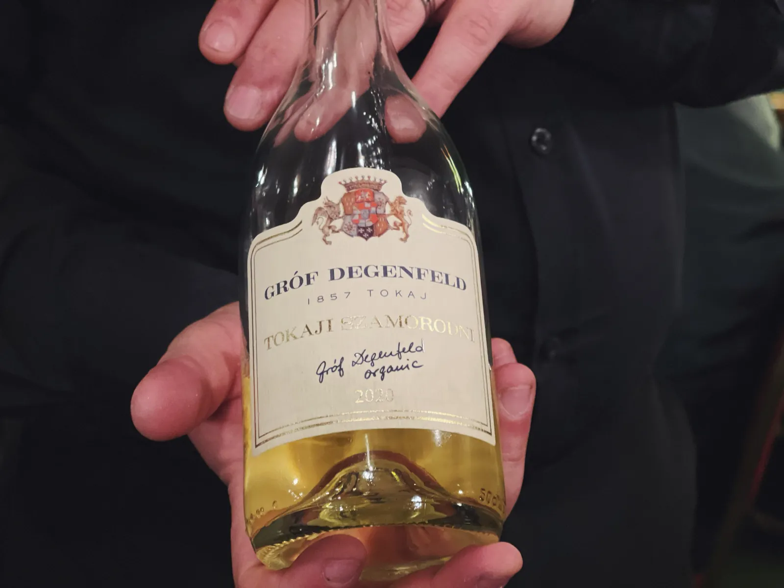 A sommelier presenting a bottle of Hungarian Tokaji
