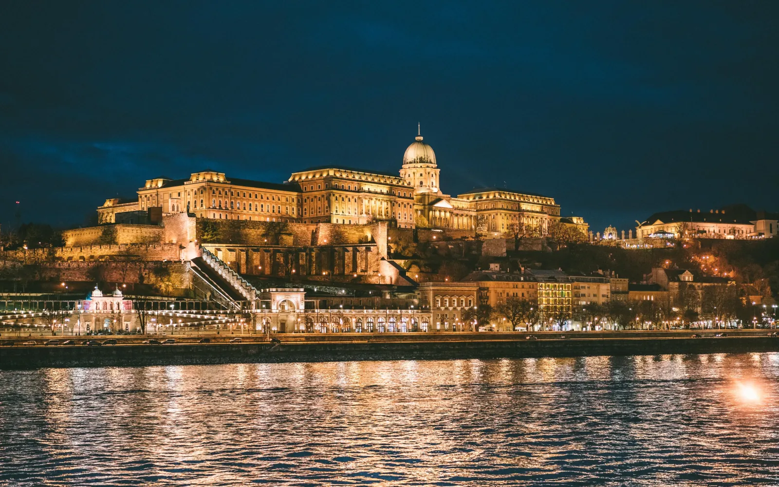Buda Castle lit up above the embankment