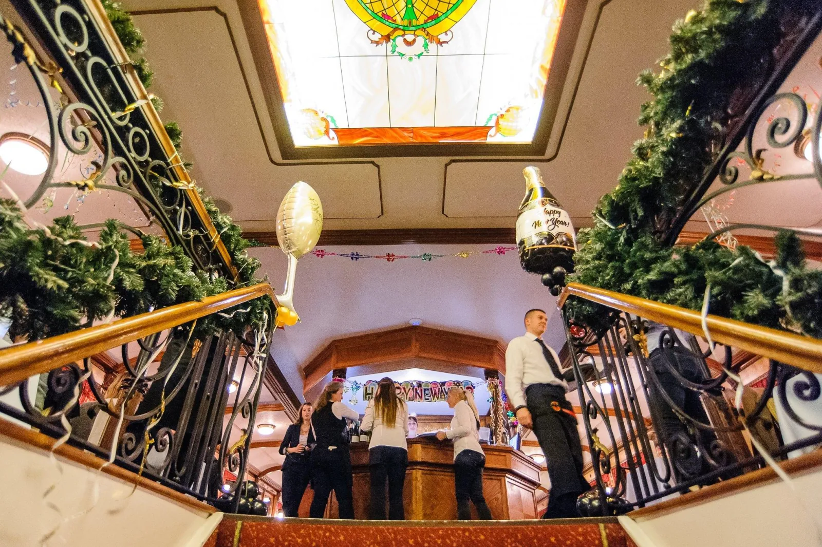 The staircase and bar decorated for the evening