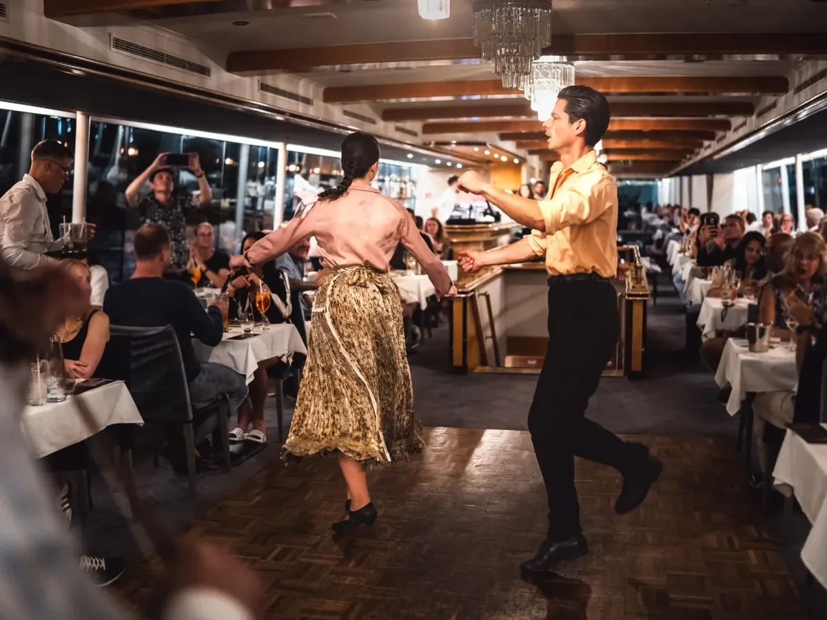Folk dancers performing between the tables during a Danube dinner cruise in Budapest
